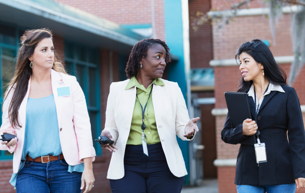 Principal in discussion with two colleagues about student engagement