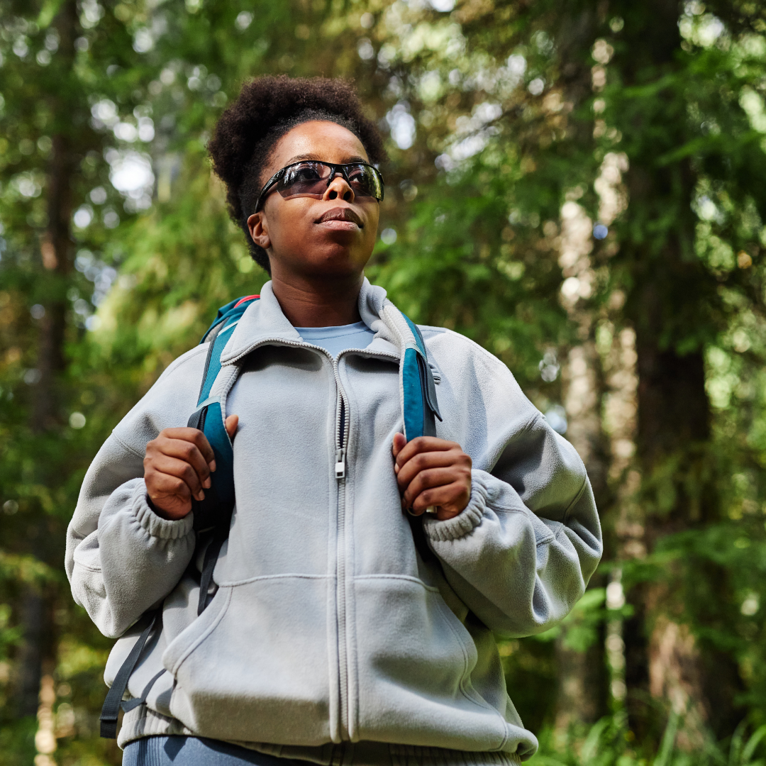 A leader pausing on a mountain path, reflecting on their resilience and personal growth.