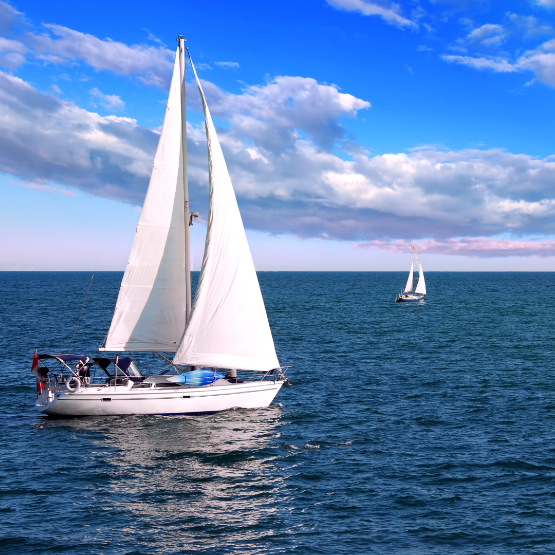 A sailboat moving through calm water, symbolizing emotional awareness and direction in uncertain waters