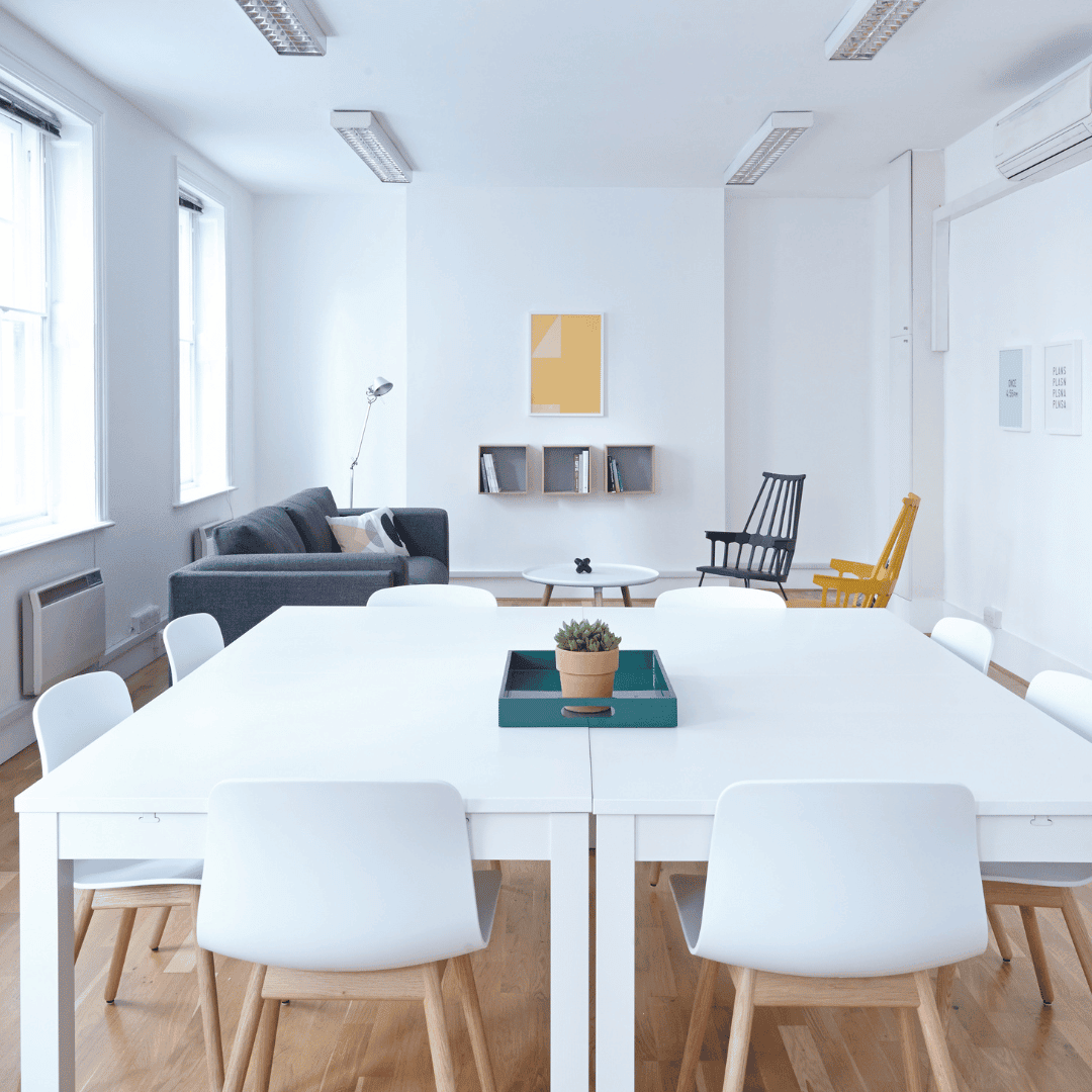A meeting room set up for an on-site leadership workshop, with chairs in a circle and a flip chart