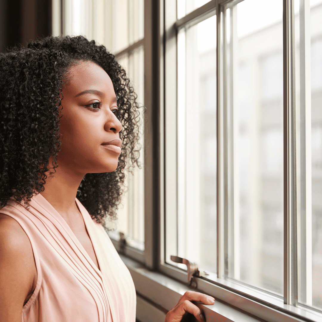 A people leader pausing between meetings during a period of organizational change