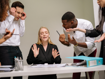 Members of a pseudo team arguing with each other while the team lead is not listening