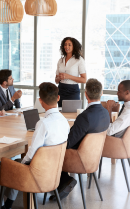 Team lead and team of eight in a meeting